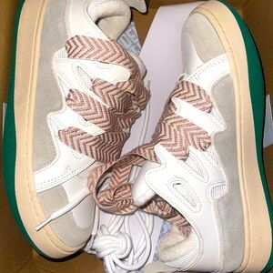 Stylish White and Beige Steve Madden Sneakers with Patterned Laces.